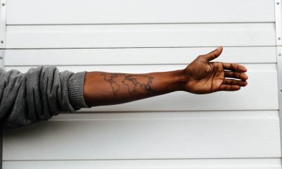 ausgestreckter Arm mit Weltkarte-Tattoo